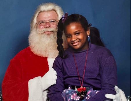 Seven-year-old Candice smiles with Santa at the Westinghouse Annual Children's Christmas Party in 1989