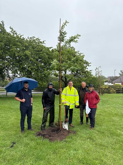 Managing Director Craig Boothby planting the final tree alongside Bev Duckwork, members of the parish council and Josh Peet from Westinghouse Springfields.1