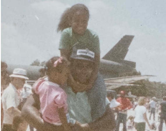 Six-year-old Candice and her sister share a moment with Erby at an air show in 1988